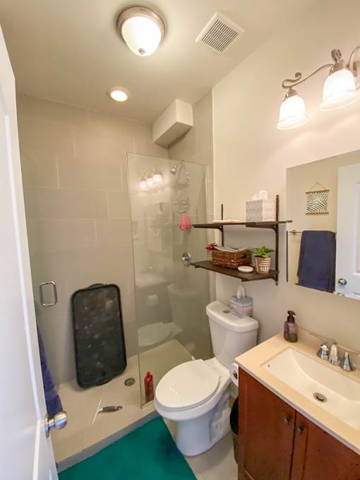 A bathroom with a toilet, sink, and shower.