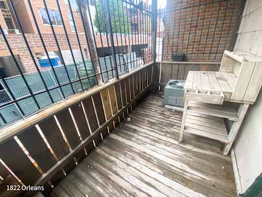 A wooden deck with a table and chairs on it.