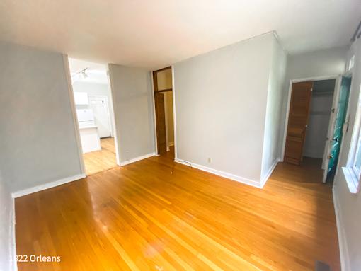 A room with wooden floors and white walls.