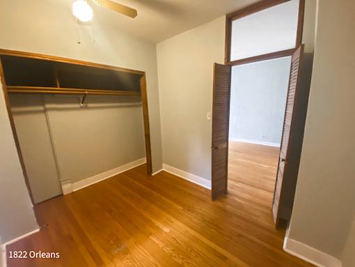 A room with a wooden floor and a large window.