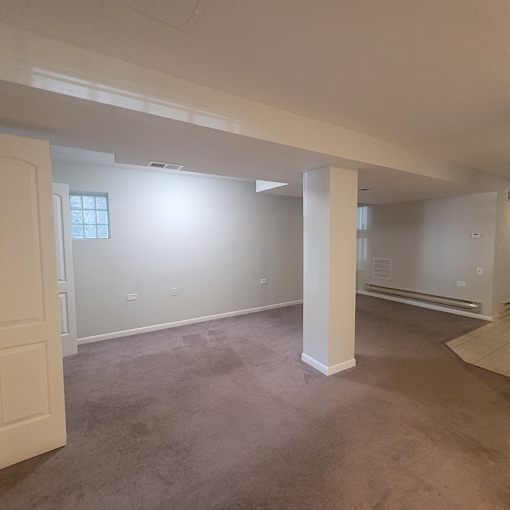 an empty living room with white walls and a concrete floor