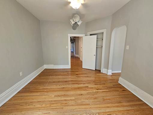 A room with wooden floors and a white door.