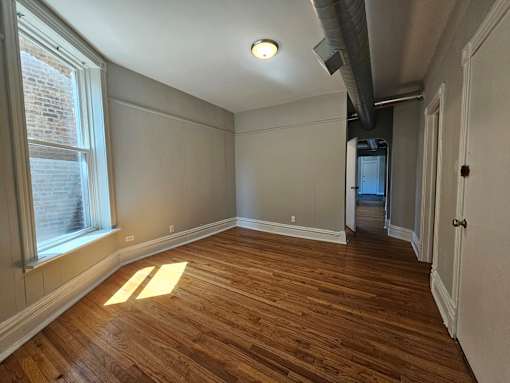 A room with wooden floors and white walls.