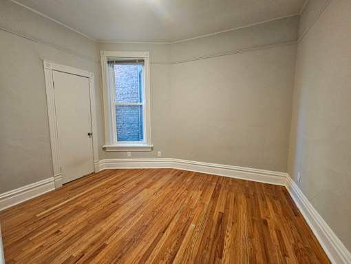 A room with wooden floors and a window.