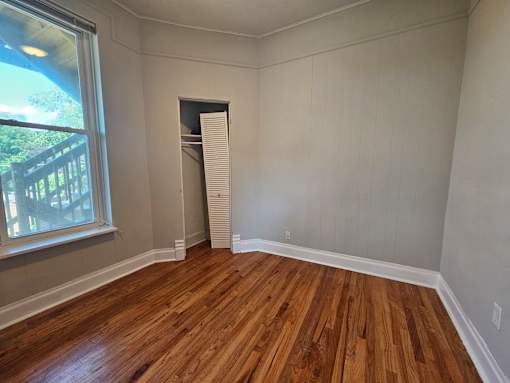 A room with wooden floors and a window.