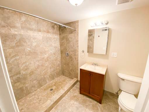 a bathroom with a toilet sink and shower