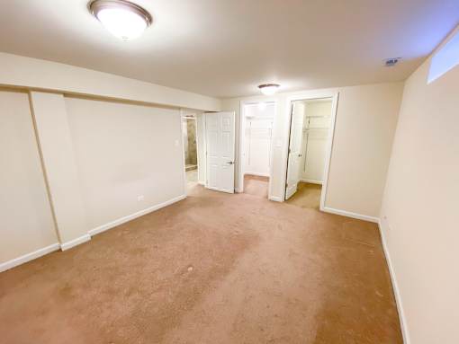 an empty room with a carpeted floor and white walls