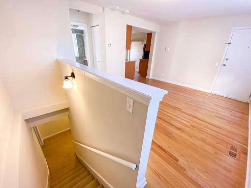a view of the living room from the top of the stairs in an empty house