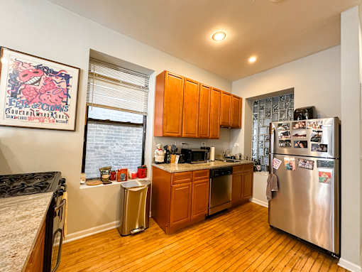 A kitchen with wooden cabinets and a fridge.