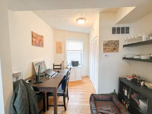 A room with a desk and a chair in it.