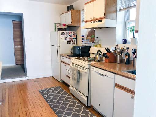 A kitchen with a white fridge and white oven.