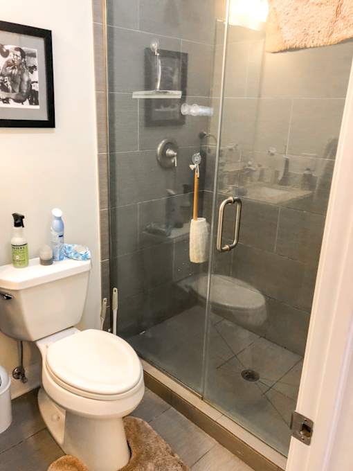a bathroom with a toilet and a shower
