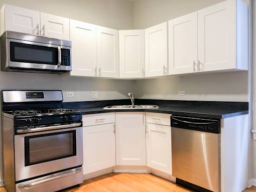 a kitchen with stainless steel appliances and white cabinets