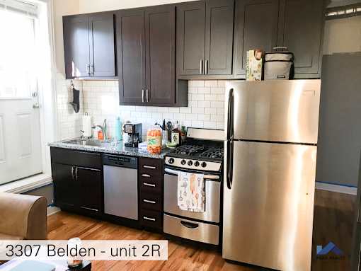 a kitchen with stainless steel appliances and black cabinets