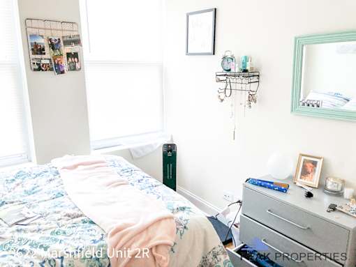 a bedroom with a bed and a dresser in it