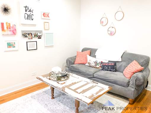 a living room with a couch and a coffee table    and a wall