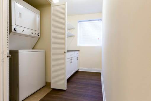A small kitchen with a white fridge and a white oven.
