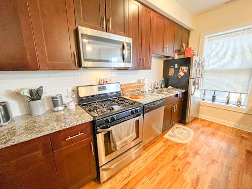 a kitchen with stainless steel appliances and wooden cabinets