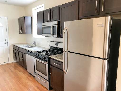 a kitchen with stainless steel appliances and black cabinets