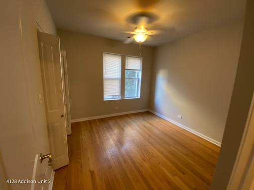 the interior of a house with wooden floors and a ceiling fan
