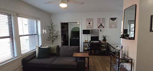 A living room with a grey couch and a coffee table.