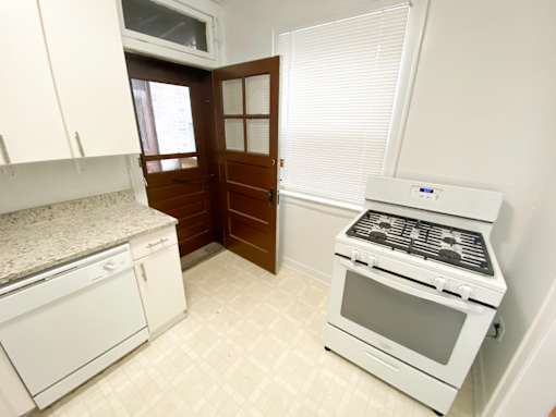 A white kitchen with a stove and oven.