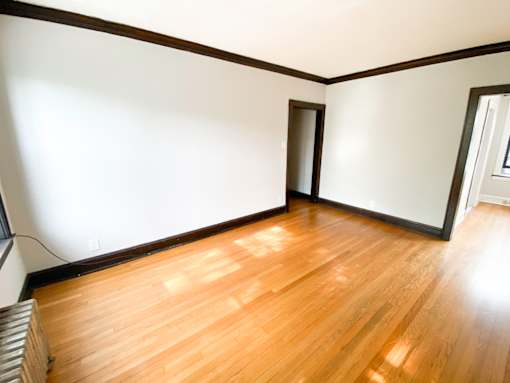 A room with wooden floors and white walls.