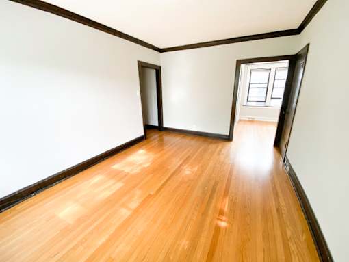 A room with wooden floors and white walls.