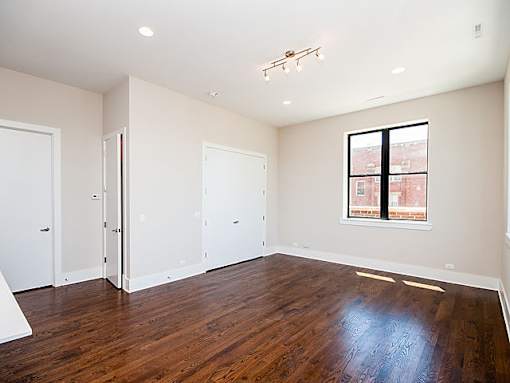 Empty room with wood floors and a window.
