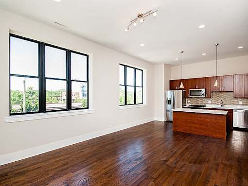 A kitchen with a wooden counter and a window.