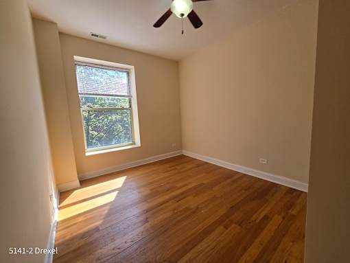 the living room of a house with wooden floors and a window