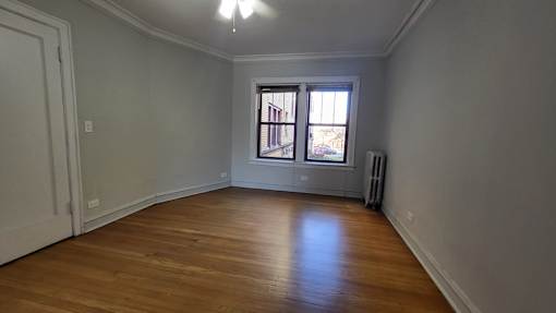 a living room with a window and wooden floors