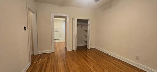 A room with wooden floors and white walls.