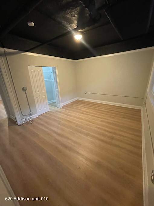 the living room has a hard wood floor and a black ceiling