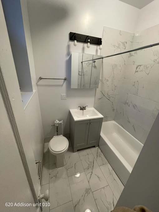 a small bathroom with a toilet sink and tub