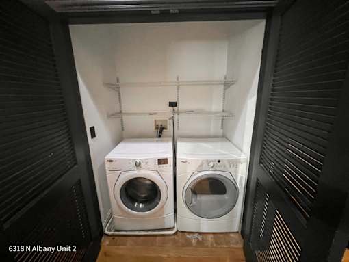 a small laundry room with a washing machine and a dryer