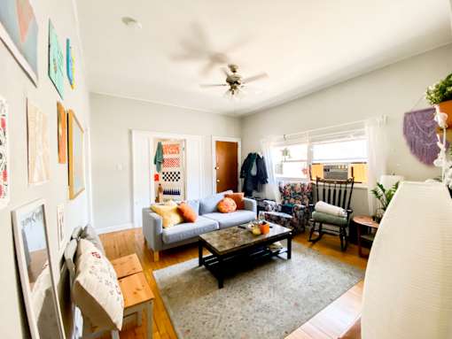 A living room with a couch, chairs, and a coffee table.