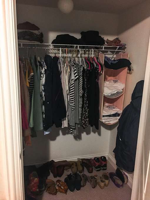 A closet full of clothes and shoes.