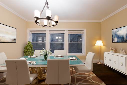 a dining room with a table and chairs and a chandelier