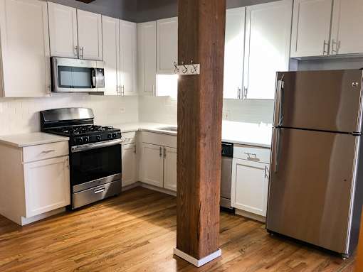 A kitchen with a refrigerator, stove, and oven.