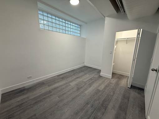 A room with a grey floor and a white door.