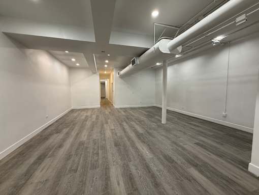 A room with a grey floor and white walls.