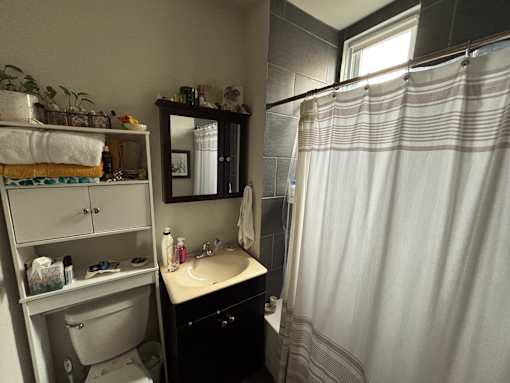 A bathroom with a sink, mirror, and toilet.