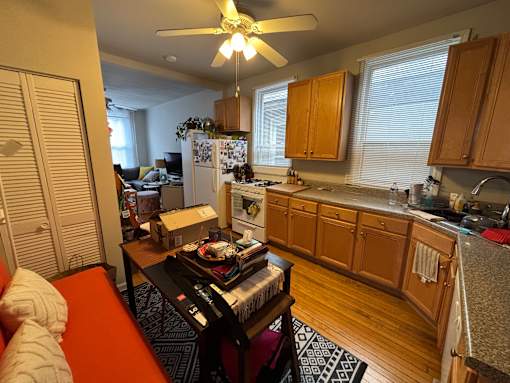 A kitchen with wooden cabinets and a white fridge.