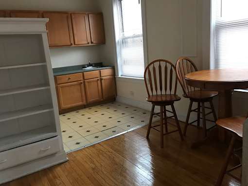 A kitchen with wooden floors and a checkered floor.