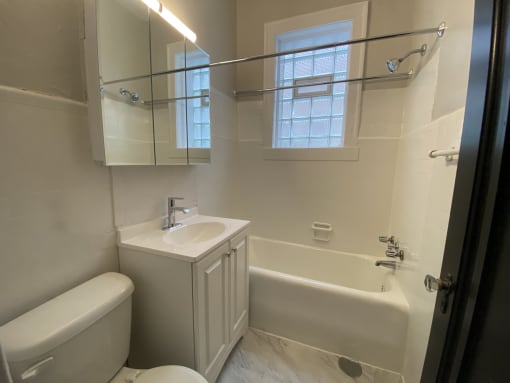 a small bathroom with a sink toilet and bath tub