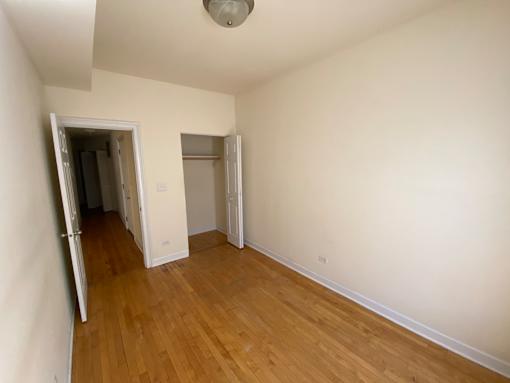 A room with wooden floors and white walls.