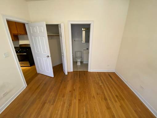 A kitchen with a white door open to a hallway.