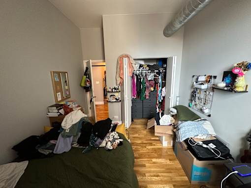 A room with a bed, a wardrobe and a desk.