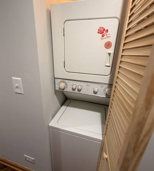 A white oven with a red flower sticker on the door.